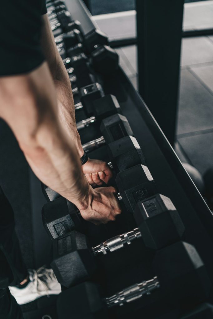The Art of Drawing Readers In: Your attractive post title goes here a-man-is-doing-exercises-with-dumbs-in-a-gym-t9bg-foxqma