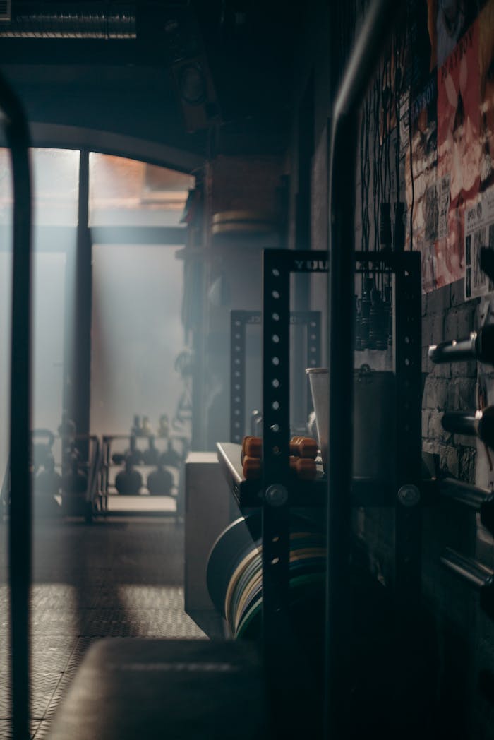 Mastering the First Impression: Your intriguing post title goes here A dark and atmospheric gym interior showcasing weights and fitness equipment with dramatic lighting.